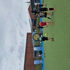 A football game on astroturf with a massive darts-board style goal