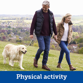 Two people and a dog on a walk