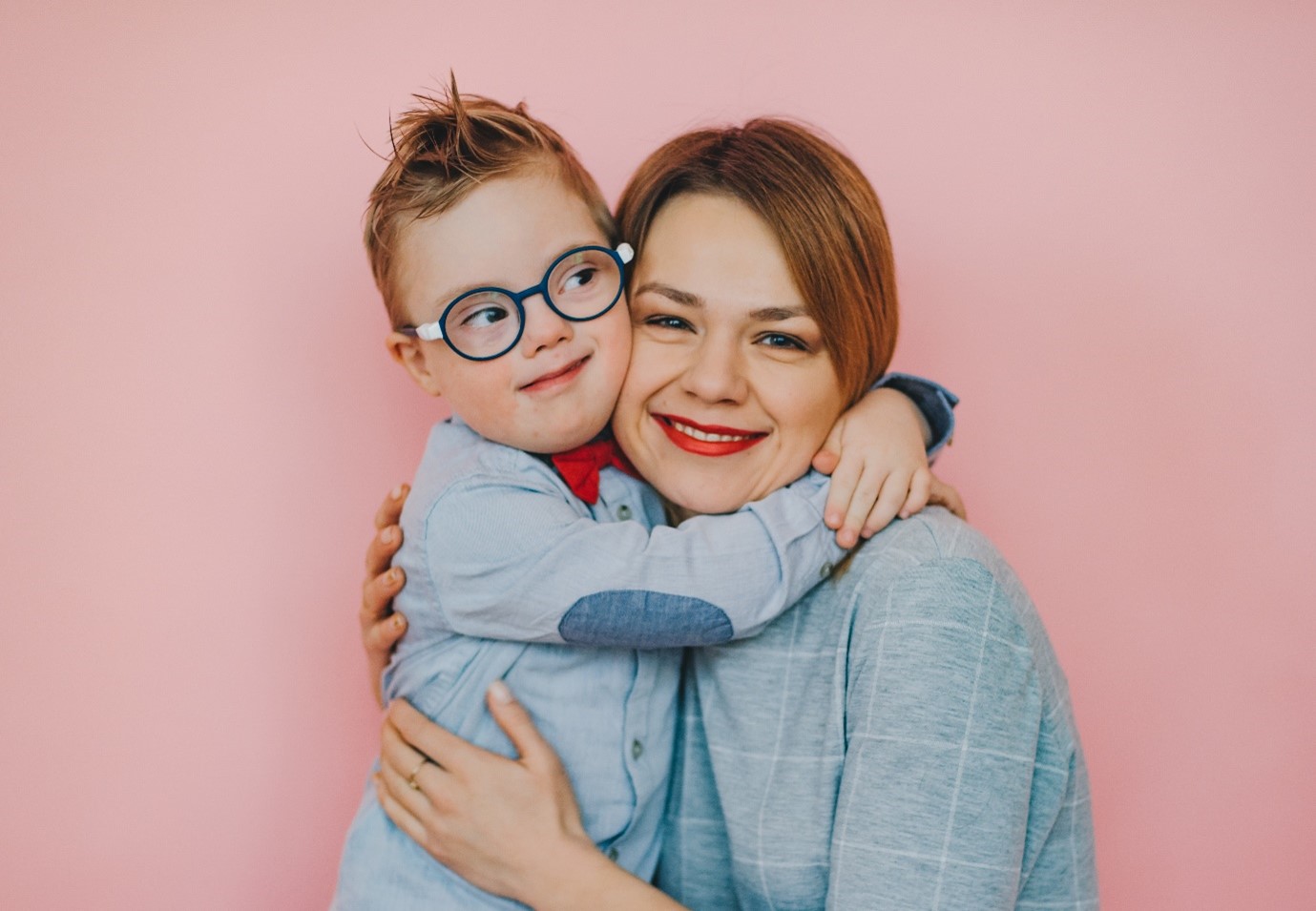 Smiling child and woman embracing