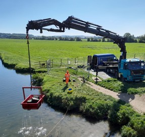 Crane holding diving equipment needed to retrieve parts of the bridge from the water.