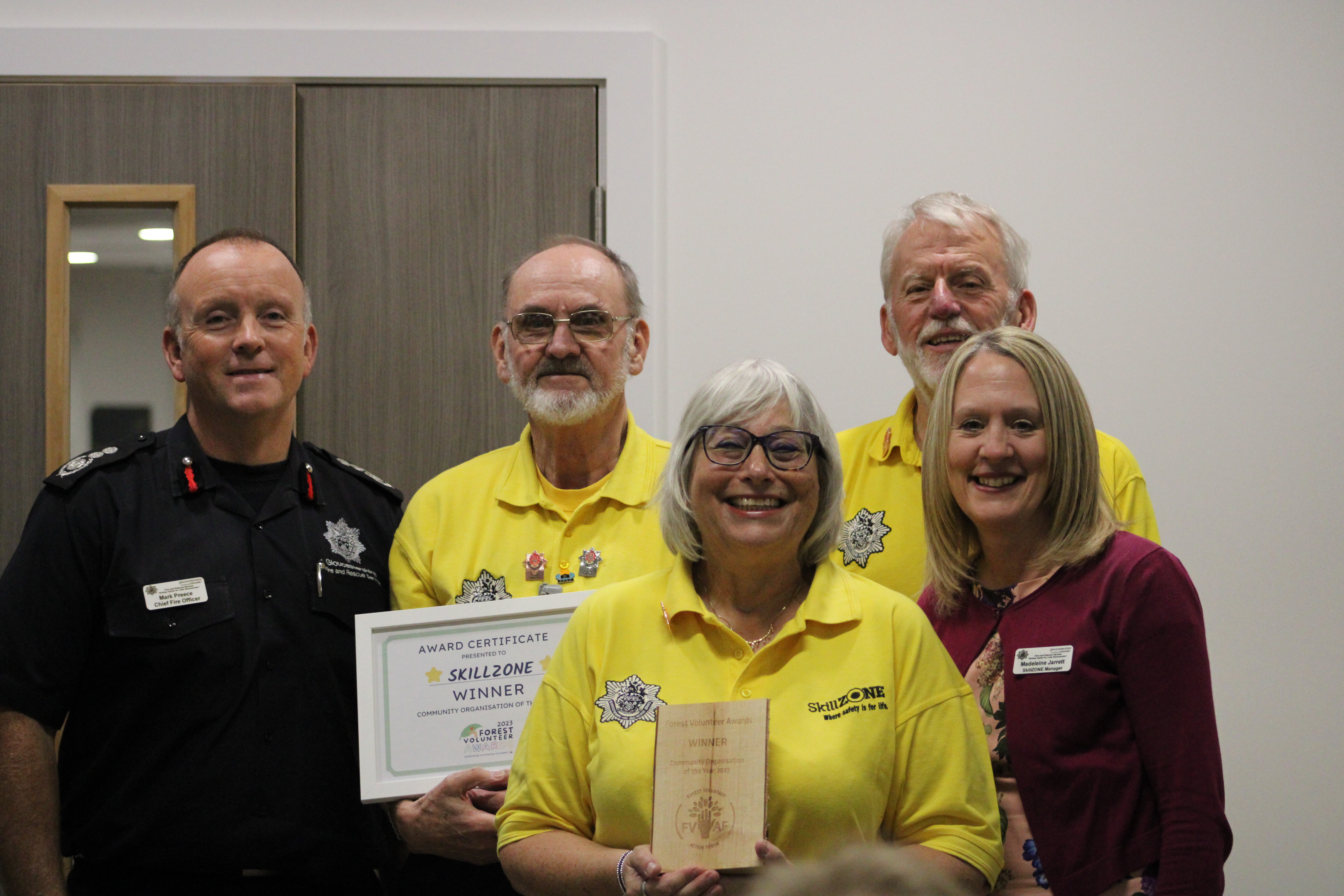 Chief Fire Officer, Mark Preece, SkillZONE Manager, Madeleine Jarrett and volunteers Keith, Mike and Sue holding award at The Forest Volunteer Awards.