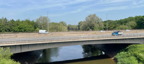 Photo of Over Bridge taken from the side showing vans crossing