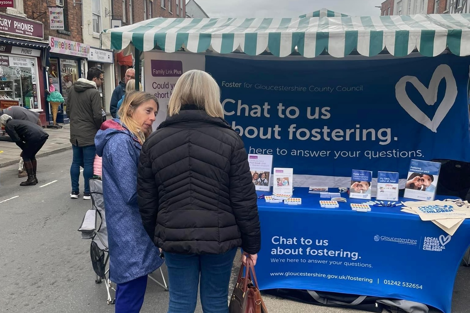 fostering event stall - two people chatting