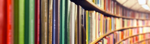 A close up image of some books on a bookshelf