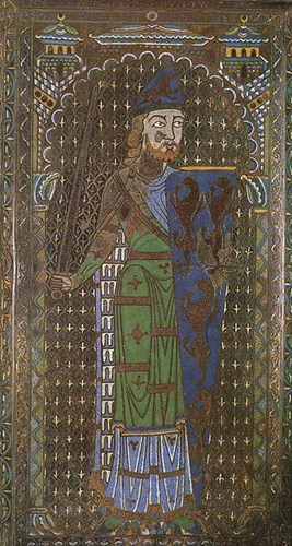A knight wearing a green surcoat over his armour and brandishing a deep blue shield