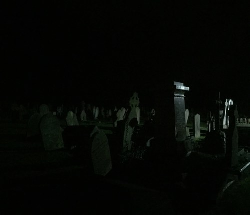 A photo of Leckhampton Parish churchyard during the night