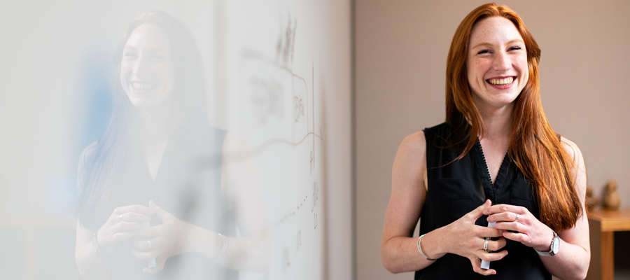 A teacher standing and smiling