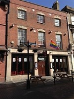 An image of the Westgate pub in Gloucester, flying a LGBTQ+ pride flag