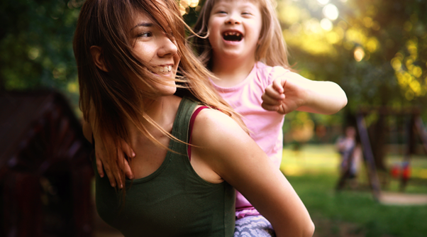 Woman carrying a girl on her back