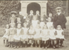 A black and white photo of a school class with their teachers.