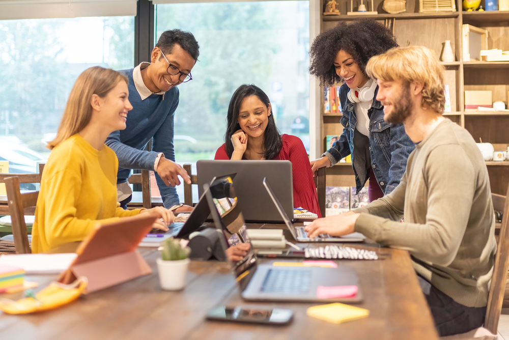 Five people working at a table together