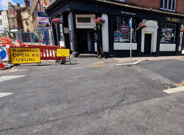 A street with a car parked in front of a building

AI-generated content may be incorrect., Picture