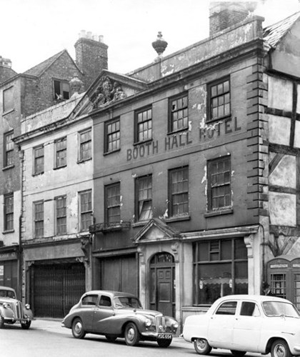 A photo of the Booth Hall just before it was demolished. One of the windows is shattered and the paint on the façade is chipping away. The façade still reads 'Booth Hall Hotel'