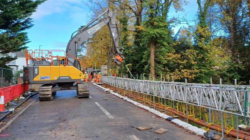 Photo of large yellow digger within road closure area