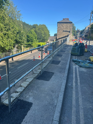 Photo of new fence installed along pavement edge