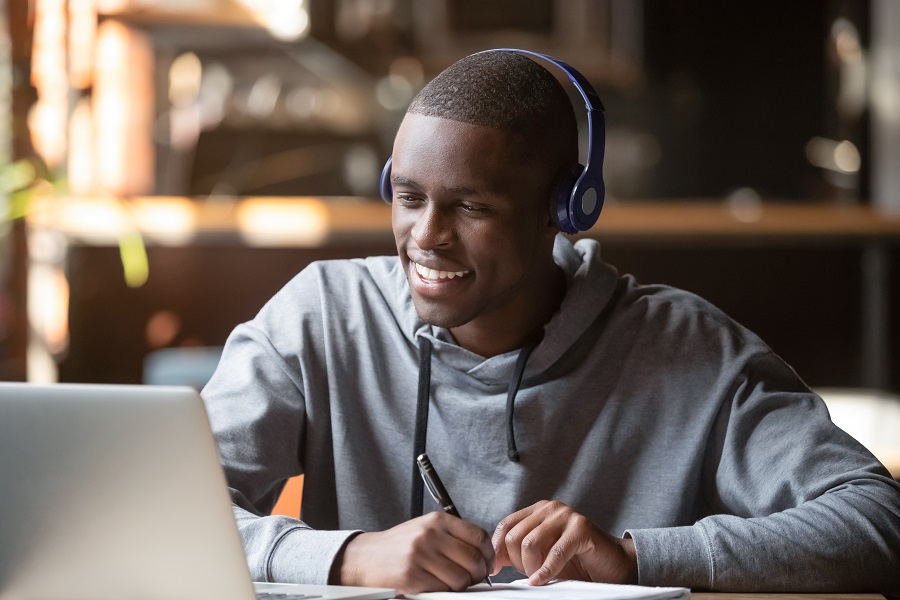 A Man On A Video Call Smiles At His Laptop