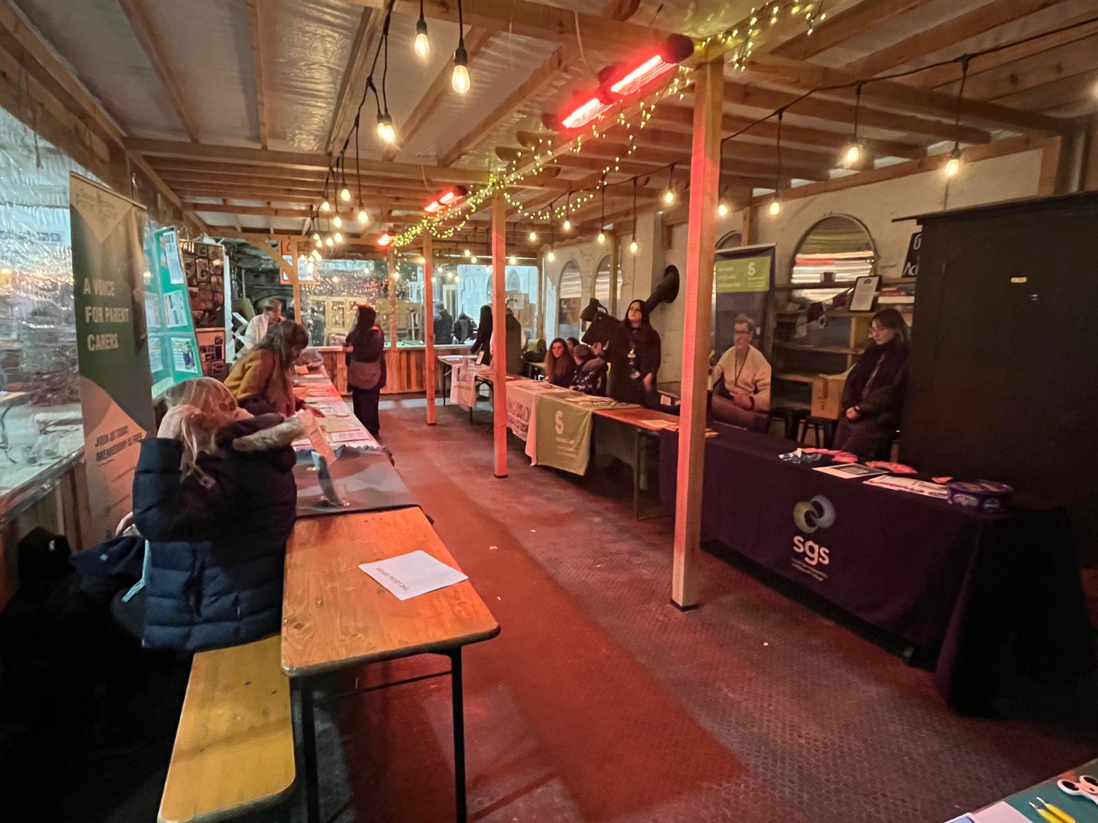 A range of stallholders at Brimscombe Mill prepare to showcase their services under festoon and fairy lights.