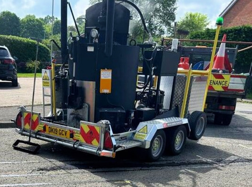 Photo of Roadmender machine on a sunny street