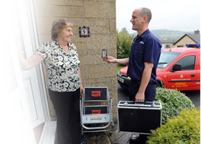 An image of a woman on her doorstep having a conversation with a man