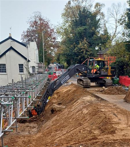 Photo of digger removing earth from below the road surface level