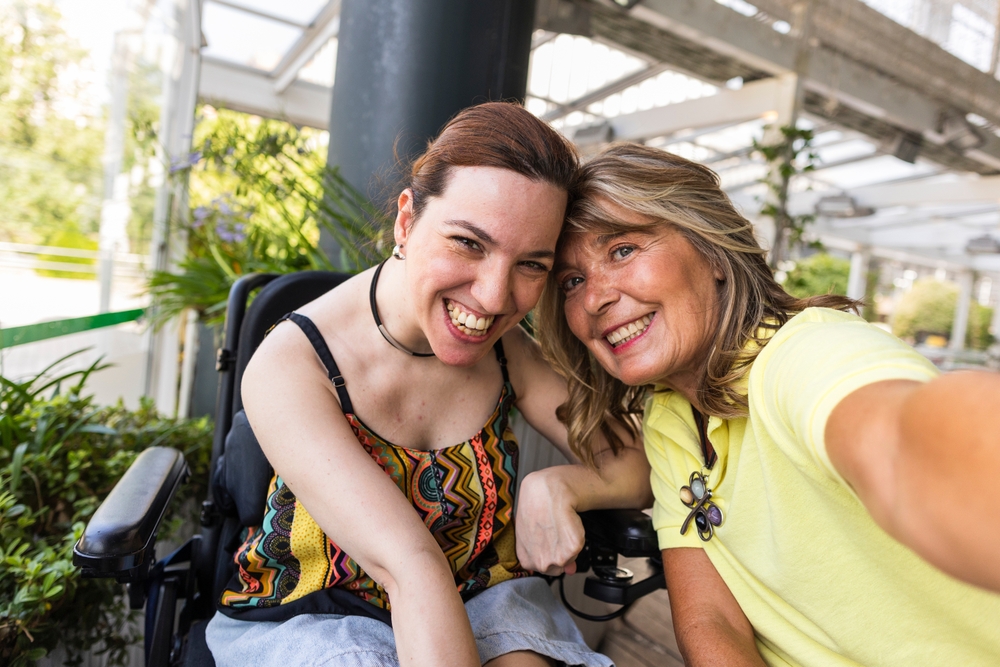 Young woman and a caregiver smiling