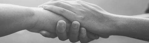 A photo of one person holding another person's hand in their's