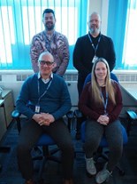 A picture of the Independent Travel Training team. They are four people - three men and one woman. Two are sat down while the other two stand behind them.