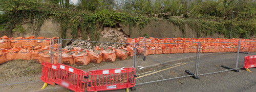 Photo of fencing around closed path and fallen wall