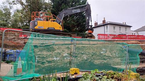 Photo of work area from below with digger on top of road