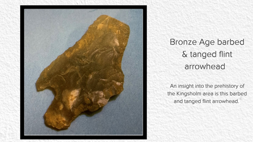 A photo of a Bronze Age barbed and tanged flint arrowhead