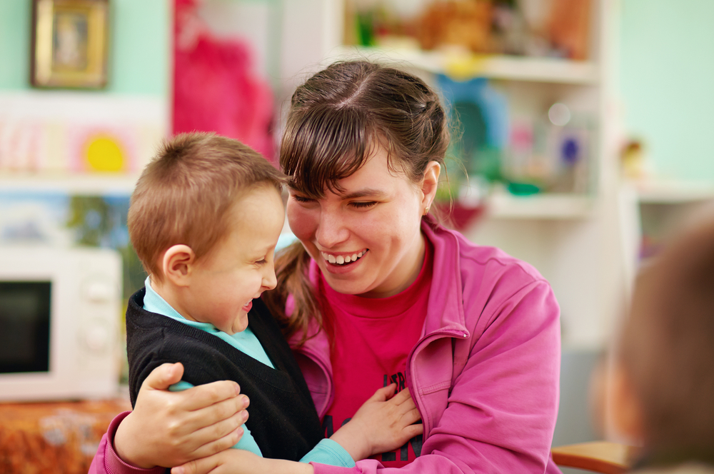 Young child being cared for by a special needs care assistant