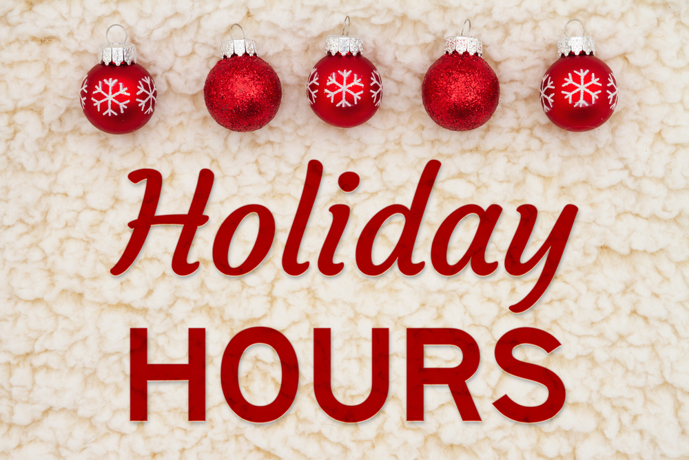 Holiday hours written in red with 5 red baubles. 