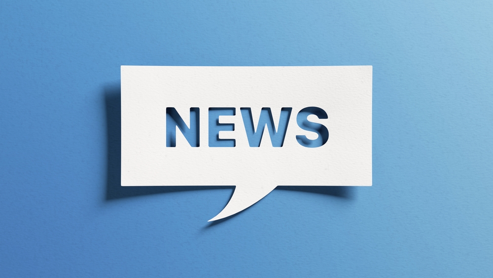 News written in a speech bubble off a blue background