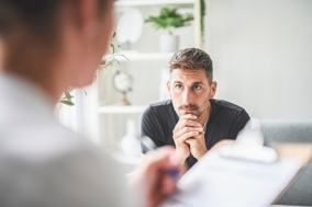 A young man having a difficult conversation with someone.