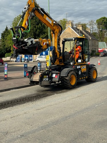 Photo of JCB machine making a repair to a road