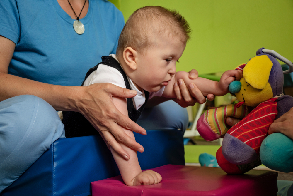18-month old child in soft play with toy