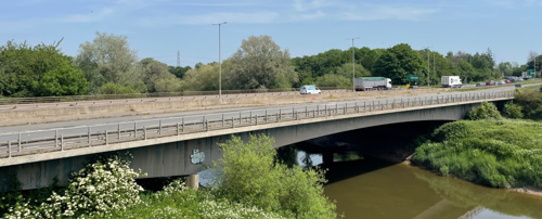 Side view photo of Over Bridge with a lorry, van and several cars crossing