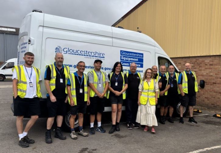 Colleagues next to a new electric van